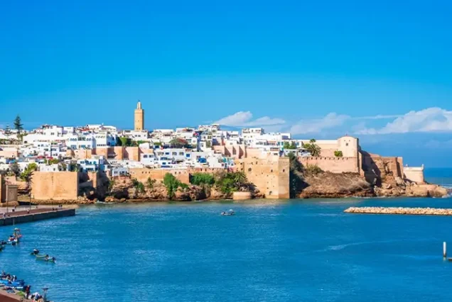 The ancient walls and gate of the Kasbah des Oudayas in Rabat, Morocco, showcasing traditional architecture with views of the river and sea.