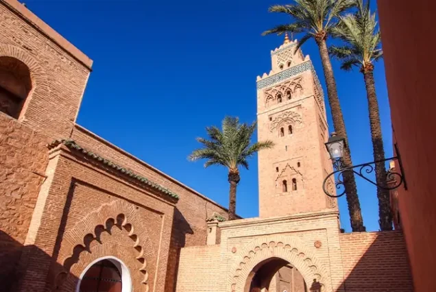 A vibrant view of the bustling streets in the Medina of Marrakech, Morocco, showcasing traditional market stalls and Moroccan architecture.